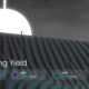 Screenshot from the Pendle homepage showing a dramatic landscape with a person standing at the edge of a sand dune under a large, bright circular light. The text on the image reads 'Liberating Yield' and displays fixed yield percentages for stETH (4.06%), eETH (23.27%), and rsETH (19.81%). There is also a button labeled 'Earn Now'.