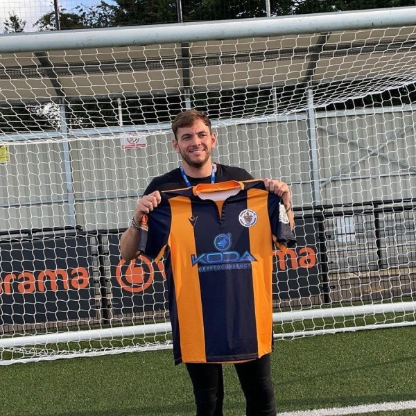 James Gale holding the Koda football shirt