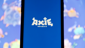 The Axie Infinity (AXS) logo is displayed on a mobile phone screen.