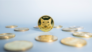 Shiba Inu (SHIB-USD) or Shib coin placed in the center among a pile of cryptocurrencies on a blue background. Close-up, soft focus. Banner with golden Shiba token.